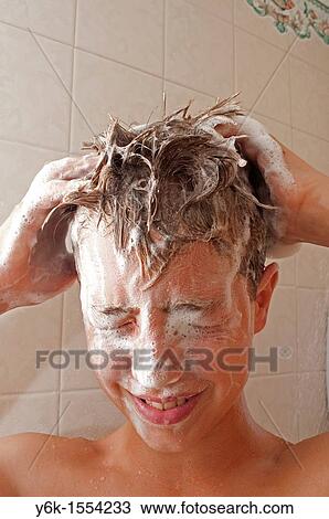 Stock Image - a teenage boy washing his hair in the shower. Fotosearch