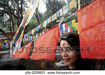 A teenage girl with a Hindu tilaka marking walks under prayer flags at Tiger Hill. View Large Photo Image Stock Image - A teenage girl with a Hindu tilaka marking walks under prayer flags at Tiger Hill.. Fotosearch