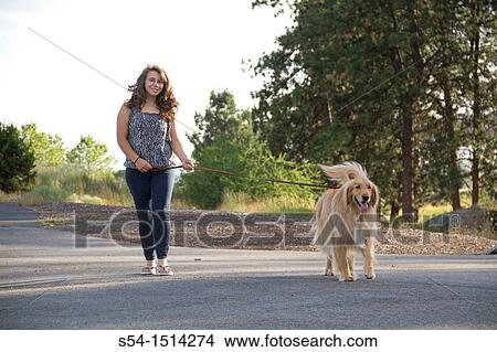 A teenaged Caucasian girl walking her Golden Retriever on the Centennial Trail in Spokane, Washington, USA View Large Photo Image Picture - A teenaged Caucasian girl walking her Golden Retriever on the Centennial Trail in Spokane, Washington, USA. Fotosearch