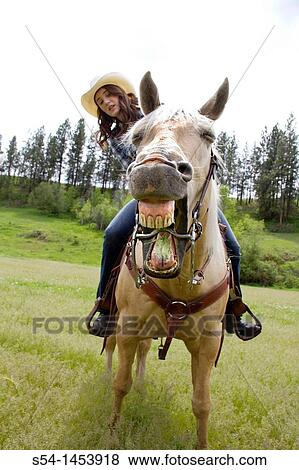 Stock Photo - A teenaged girl riding a horse in Reardan, Washington, USA.. Fotosearch