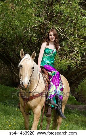 Stock Image - A teenaged girl riding a horse. Fotosearch