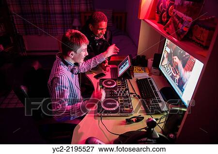 A teenager playing a DJ music set on a livestream internet connection from his bedroom in the Uk. View Large Photo Image Stock Photo - A teenager playing a DJ music set on a livestream internet connection from his bedroom in the Uk.. Fotosearch