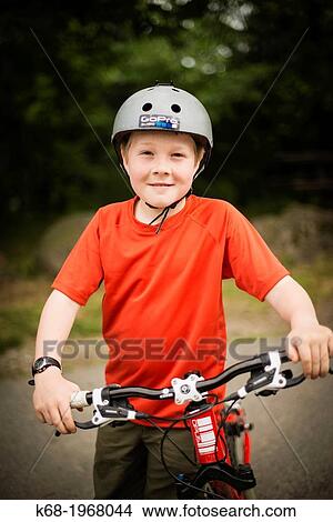 Picture - A ten year old boy with his bicycle on Saturna Island, Gulf Islands, British Columbia, Canada. Fotosearch