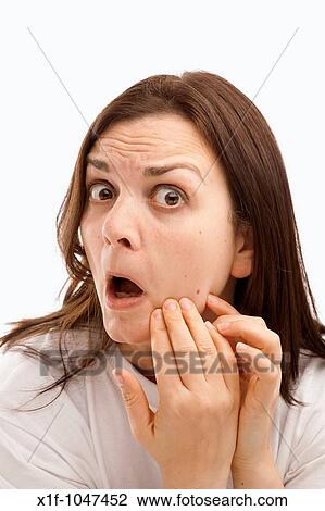 a thirty year old woman looking at her complexion, checking her face View Large Photo Image Stock Image - a thirty year old woman looking at her complexion, checking her face. Fotosearch