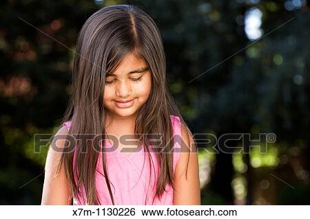 A thoughtful little Indian girl View Large Photo Image Stock Photograph - A thoughtful little Indian girl. Fotosearch