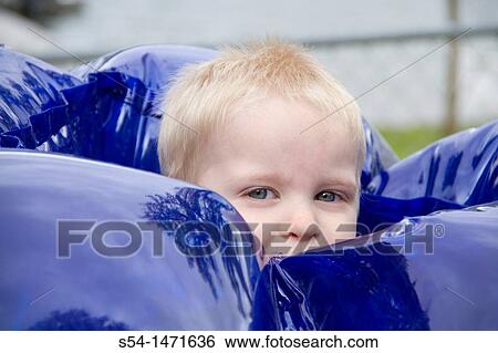 A three-year-old caucasian boy playing in an inflatable ball. View Large Photo Image Stock Photograph - A three-year-old caucasian boy playing in an inflatable ball.. Fotosearch