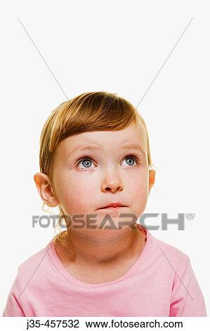 A three year old girl with blonde hair wearing a pink top and hair pulled back, looks upwards. View Large Photo Image Stock Image - A three year old girl with blonde hair wearing a pink top and hair pulled back, looks upwards.. Fotosearch