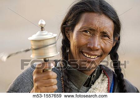 A tibetan man look in camera and play the pray wheel Ngari Prefecture Tibet province China Asia View Large Photo Image Stock Photo - A tibetan man look in camera and play the pray wheel Ngari Prefecture Tibet province China Asia. Fotosearch