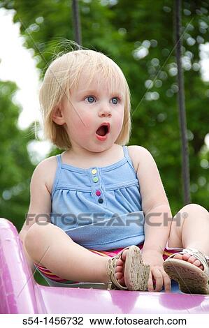 Stock Image - A toddler at the park, with a surprised expression.. Fotosearch