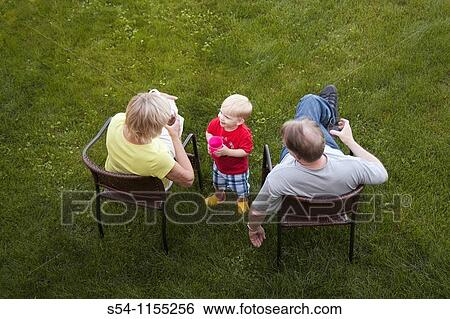 A toddler smiling with his grandparents View Large Photo Image Stock Photograph - A toddler smiling with his grandparents. Fotosearch