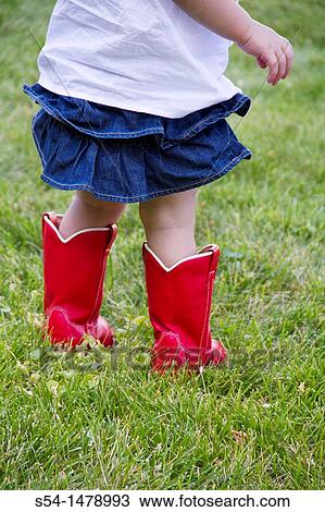 A toddler standing in a lawn wearing bright red boots. View Large Photo Image Stock Image - A toddler standing in a lawn wearing bright red boots.. Fotosearch