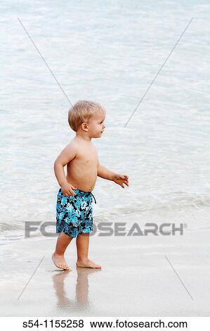 A toddler walks on the beach in Kailua, Oahu, Hawaii View Large Photo Image Stock Photo - A toddler walks on the beach in Kailua, Oahu, Hawaii. Fotosearch