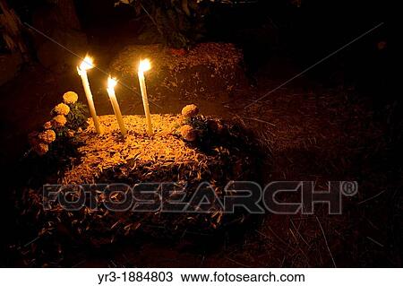 A tomb is decorated with candles and flowers in the cementery of San Gregorio Atlapulco, Xochimilco on the outskirts of Mexico City, November 1, 2012, on the Day of the Dead celebration, a tradition that honors the deceased View Large Photo Image Stock Image - A tomb is decorated with candles and flowers in the cementery of San Gregorio Atlapulco, Xochimilco on the outskirts of Mexico City, November 1, 2012, on the Day of the Dead celebration, a tradition that honors the deceased. Fotosearch