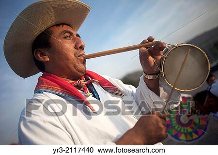 A Totonacan indigenous man plays flute and drums from Papantla, Veracruz, as part of the Dance of the Guaguas at the pilgrimage to Our Lady of Guadalupe Basilica in Mexico City, Mexico, December 10, 2013. View Large Photo Image Stock Image - A Totonacan indigenous man plays flute and drums from Papantla, Veracruz, as part of the Dance of the Guaguas at the pilgrimage to Our Lady of Guadalupe Basilica in Mexico City, Mexico, December 10, 2013.. Fotosearch