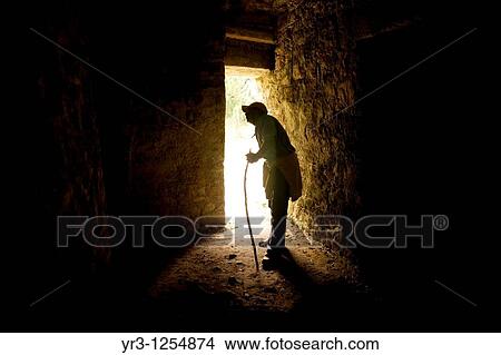 Picture - A tour guide walks through the Labyrinth of Building 19 in the ancient Mayan city of Yaxchilan, Frontera Corozal, Chiapas, Mexico.. Fotosearch