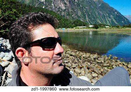 A tourist explores Fiordland, southern New Zealand. View Large Photo Image Stock Image - A tourist explores Fiordland, southern New Zealand.. Fotosearch