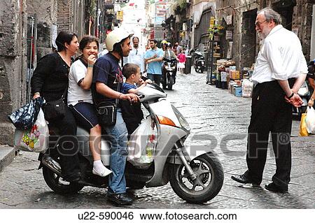 A tourist watching a whole family on a scooter. Naples. Italy View Large Photo Image Stock Photograph - A tourist watching a whole family on a scooter. Naples. Italy. Fotosearch