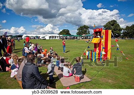 Stock Photo - A Traditional Punch and Judy Show, Hartfield Village Fete, Hartfield, Sussex, England.. Fotosearch