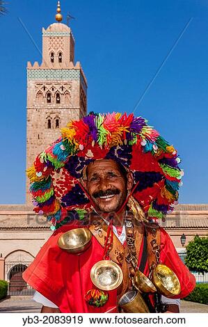 A Traditional Waterseller and Koutoubia Mosque, Marrakech, Morocco. View Large Photo Image Stock Photo - A Traditional Waterseller and Koutoubia Mosque, Marrakech, Morocco.. Fotosearch