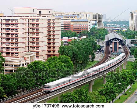 A train moves away from a station amongst public housing estates in Singapore The Mass Rapid Transit MRT is one of the main modes of public transport in Singapore and handles up to a third of the nation's population everyday View Large Photo Image Stock Photograph - A train moves away from a station amongst public housing estates in Singapore The Mass Rapid Transit MRT is one of the main modes of public transport in Singapore and handles up to a third of the nation's population everyday. Fotosearch