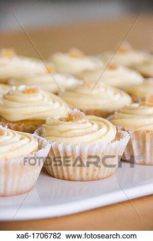 A tray of ginger cupcakes with icing View Large Photo Image Stock Image - A tray of ginger cupcakes with icing. Fotosearch