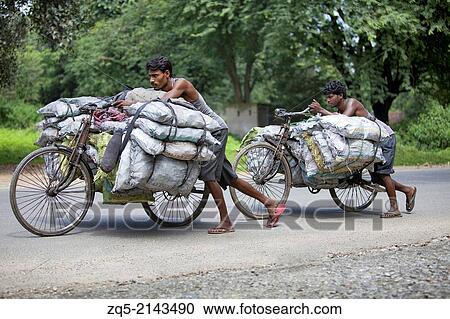 A tribal man carrying coals from village to town on bicycle. Munda tribe. Bariatu near Ranchi District Jharkhand, India. View Large Photo Image Stock Image - A tribal man carrying coals from village to town on bicycle. Munda tribe. Bariatu near Ranchi District Jharkhand, India.. Fotosearch