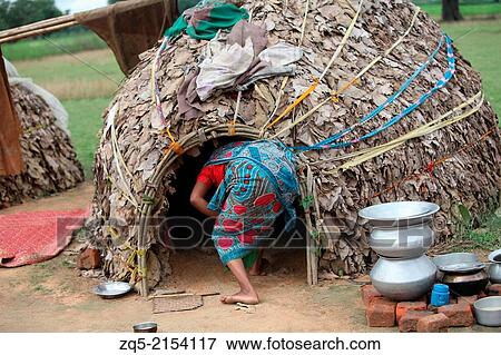 Stock Photo - A tribal woman entering her hut. Keredari village and block, District Hazaribaug, Jharkhand, India.. Fotosearch