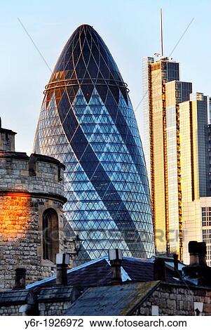A turret of the Tower of London in the foreground, with the Swiss Re Building -? the gherkin? - and the Heron Tower in the background, in the City of London financial district, on a sunny day in England View Large Photo Image Stock Image - A turret of the Tower of London in the foreground, with the Swiss Re Building -? the gherkin? - and the Heron Tower in the background, in the City of London financial district, on a sunny day in England. Fotosearch