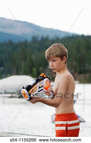 A twelve-year-old boy plays with a squirt gun View Large Photo Image Stock Photograph - A twelve-year-old boy plays with a squirt gun. Fotosearch