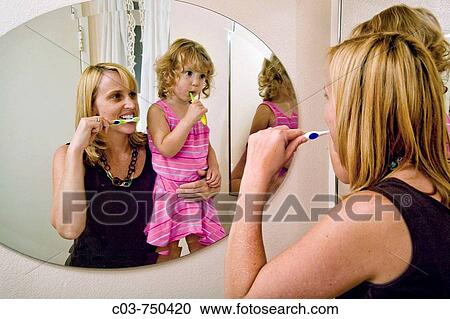 A two-year-old girl and her mother brush their teeth at home View Large Photo Image Stock Image - A two-year-old girl and her mother brush their teeth at home. Fotosearch