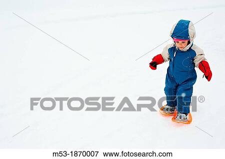 A two years old baby girl using snowshoes for her first time View Large Photo Image Stock Photo - A two years old baby girl using snowshoes for her first time. Fotosearch
