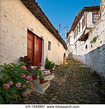A typical narrow cobbled alleyway with ottoman period houses in the Mangalemi district of Berat in central Albania View Large Photo Image Stock Photo - A typical narrow cobbled alleyway with ottoman period houses in the Mangalemi district of Berat in central Albania. Fotosearch