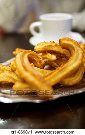 A typical Spanish breakfast called churros, served with hot chocolate View Large Photo Image Stock Image - A typical Spanish breakfast called churros, served with hot chocolate. Fotosearch