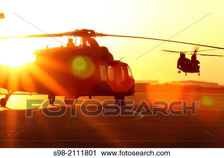 Stock Image - A UH-60 Black Hawk helicopter belonging to 2nd General Support Aviation Battalion, 1st Aviation Regiment, sits ready for a night mission.. Fotosearch