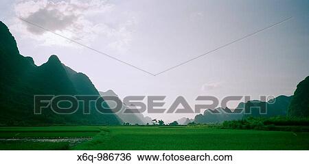 A valley in the Guangxi countryside with the Guilin mountains, China View Large Photo Image Stock Photograph - A valley in the Guangxi countryside with the Guilin mountains, China. Fotosearch
