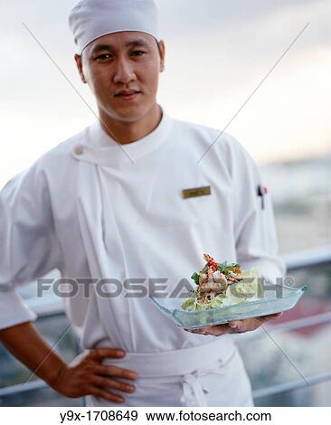 A Vietnamese chef presents a prawn salad with young mango shred at a rooftop restaurant in HoChiMin City Saigon, Vietnam View Large Photo Image Stock Photo - A Vietnamese chef presents a prawn salad with young mango shred at a rooftop restaurant in HoChiMin City Saigon, Vietnam. Fotosearch