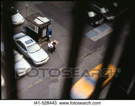 A view of a parking lot agent as a cab races by. This was shot from a firescape on Crosby Street, Soho, Manhattan. USA. View Large Photo Image Stock Image - A view of a parking lot agent as a cab races by. This was shot from a firescape on Crosby Street, Soho, Manhattan. USA.. Fotosearch