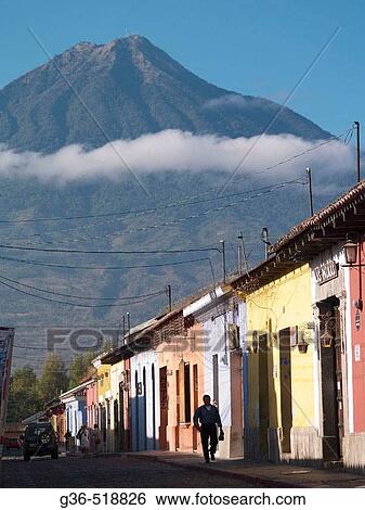 A view of the nearby vocano and the colorfully painted Colonial style houses in Antigua, Guatemala. View Large Photo Image Stock Photograph - A view of the nearby vocano and the colorfully painted Colonial style houses in Antigua, Guatemala.. Fotosearch