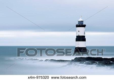 Stock Image - A view toward Penmon Point lighthouse in Wales. Fotosearch