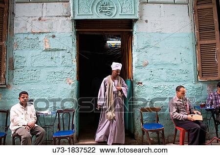 Stock Image - A visit to a local tea house in the narrow streets of Central Cairo.. Fotosearch
