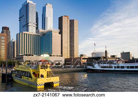 Stock Photo - A water taxi makes one of his stops near the Intrepid Sea, Air & Space Museum on the Hudson River.. Fotosearch