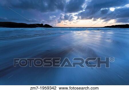 A wave sweeps back out to sea as the sun sets over Clachtoll Bay in the Scottish Highlands. View Large Photo Image Stock Image - A wave sweeps back out to sea as the sun sets over Clachtoll Bay in the Scottish Highlands.. Fotosearch