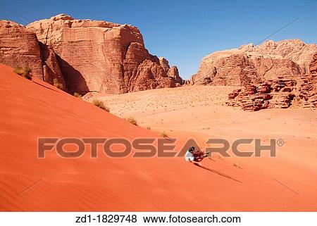 A western tourist is rolling over a sand dune in in Wadi Rum View Large Photo Image Stock Photo - A western tourist is rolling over a sand dune in in Wadi Rum. Fotosearch