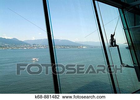 a window washer cleans windows at the Vancouver Convention Centre, Vancouver, BC, Canada. View of the port of Vancouver. View Large Photo Image Stock Image - a window washer cleans windows at the Vancouver Convention Centre, Vancouver, BC, Canada. View of the port of Vancouver.. Fotosearch