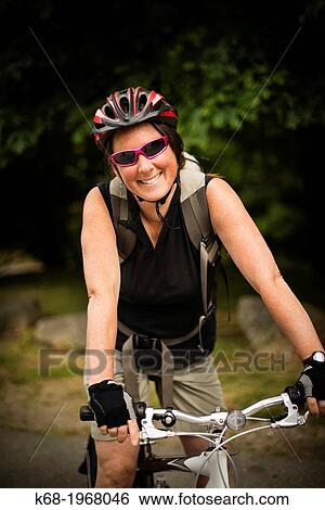 A woman, 40, bicycles on Saturna Island, Gulf Islands, British Columbia, Canada View Large Photo Image Stock Photograph - A woman, 40, bicycles on Saturna Island, Gulf Islands, British Columbia, Canada. Fotosearch