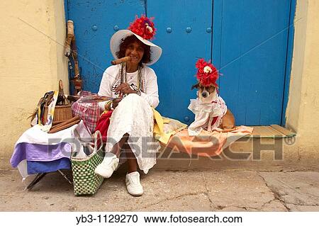 A Woman and her dog pose for pictures in return for a small payment, Old Havana, Cuba View Large Photo Image Stock Image - A Woman and her dog pose for pictures in return for a small payment, Old Havana, Cuba. Fotosearch