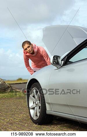 A woman by a broken down car View Large Photo Image Stock Photo - A woman by a broken down car. Fotosearch