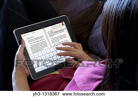 A woman demonstrating a touchscreen technology on an iPad with iPad application, iBook View Large Photo Image Stock Photo - A woman demonstrating a touchscreen technology on an iPad with iPad application, iBook. Fotosearch