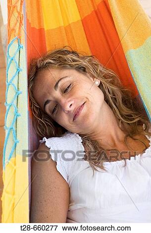 A woman dreaming in a swing View Large Photo Image Stock Photo - A woman dreaming in a swing. Fotosearch