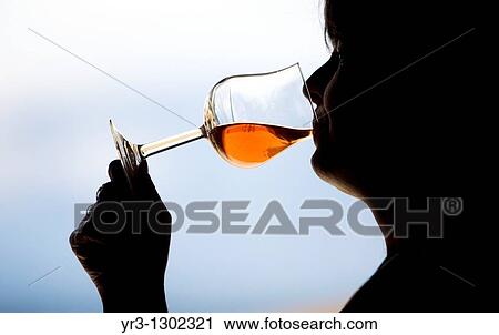 A woman drinks in a glass of red wine in Taramilla winery in Prado del Rey, Cadiz province, Andalusia, Spain, April 25, 2010 View Large Photo Image Stock Image - A woman drinks in a glass of red wine in Taramilla winery in Prado del Rey, Cadiz province, Andalusia, Spain, April 25, 2010. Fotosearch